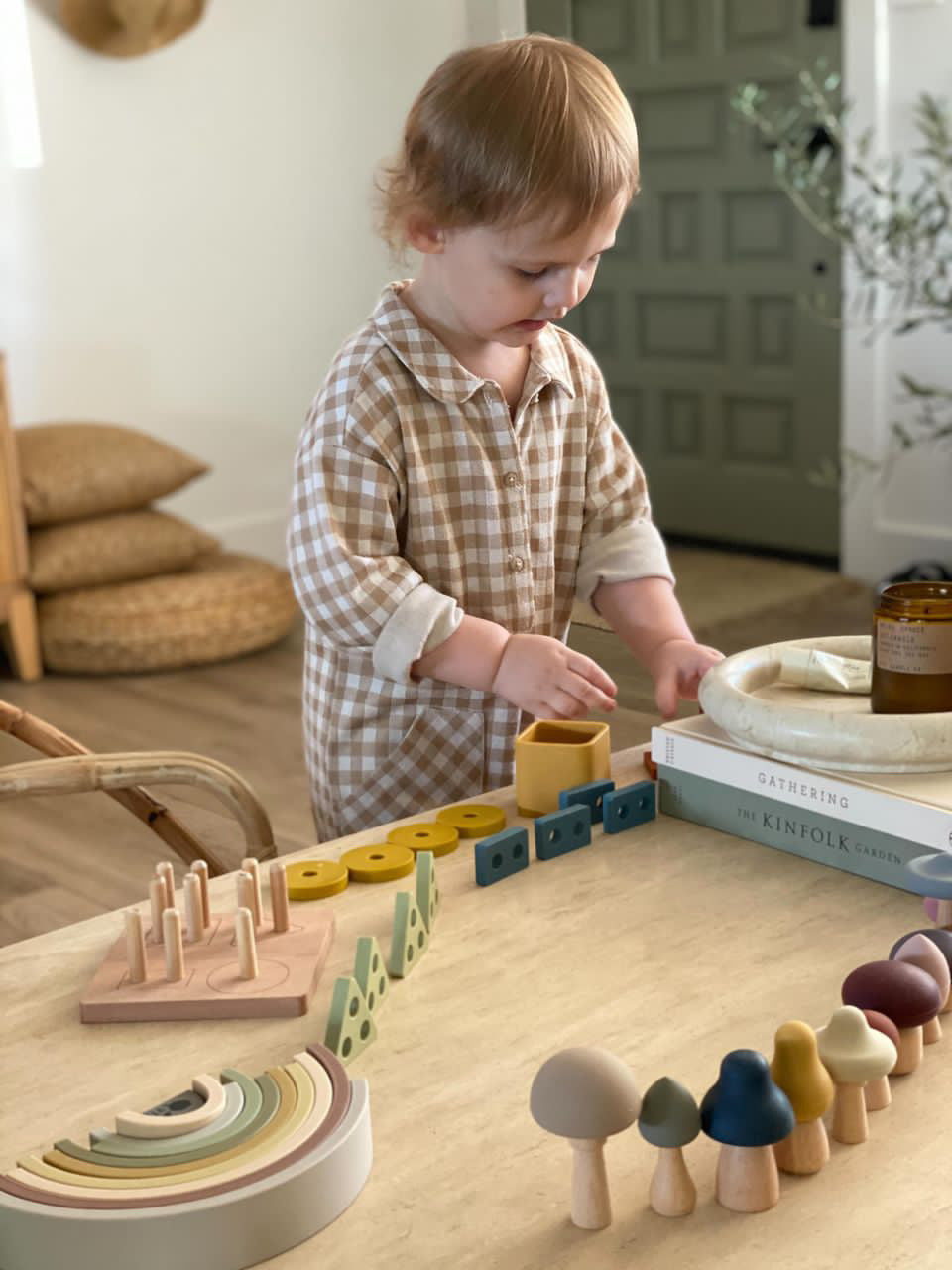 Zaiah a 2 year old playing with a variety of Lytl's Montessori Toys