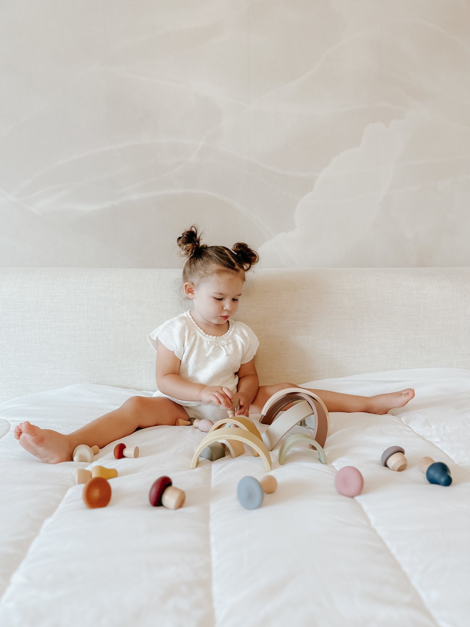 Girl playing with Lytl Mushrooms and Rainbow stacker