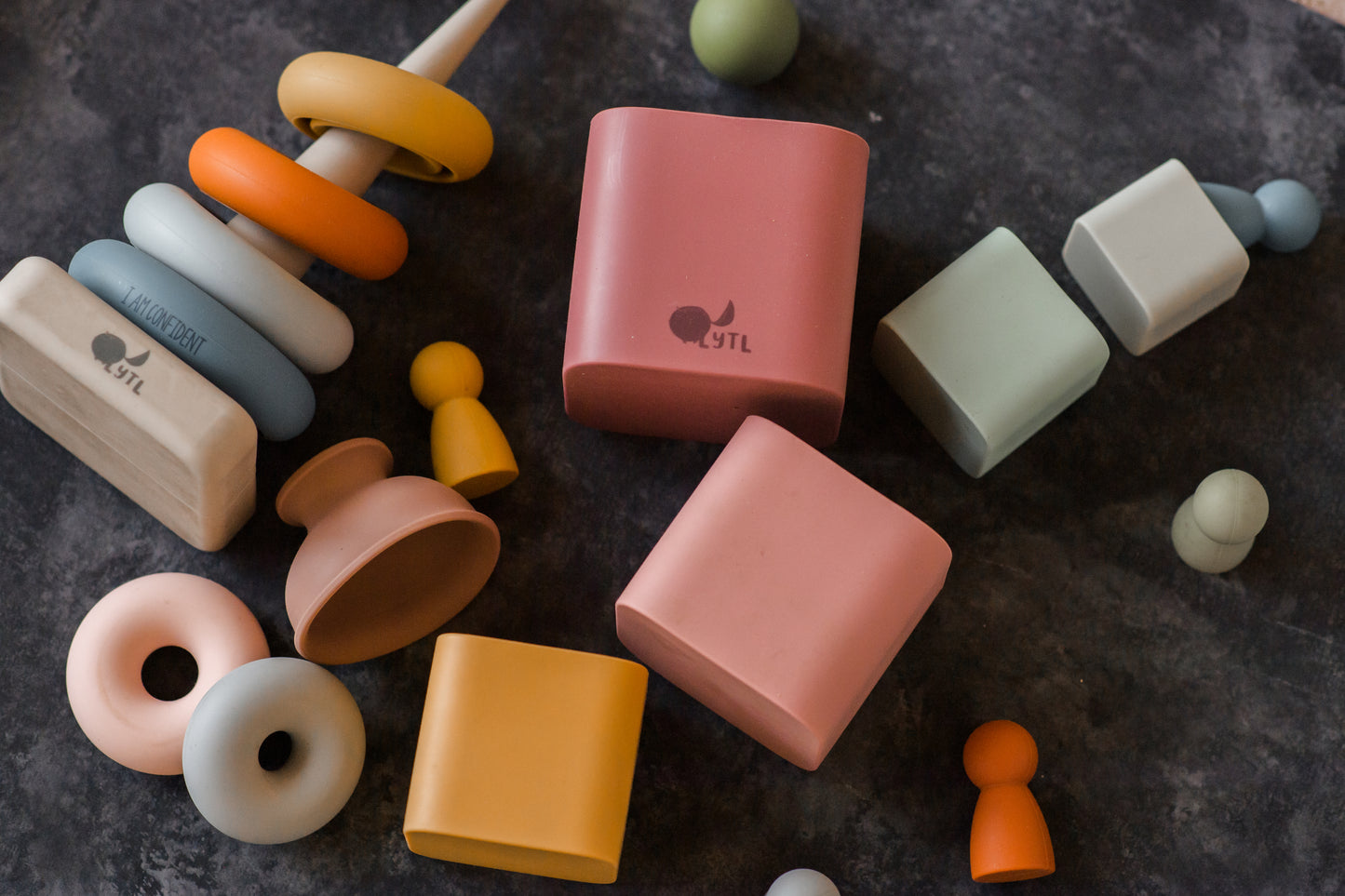 Montessori-inspired toys including stacking toys and puzzle pieces styled for imaginative and developmental play