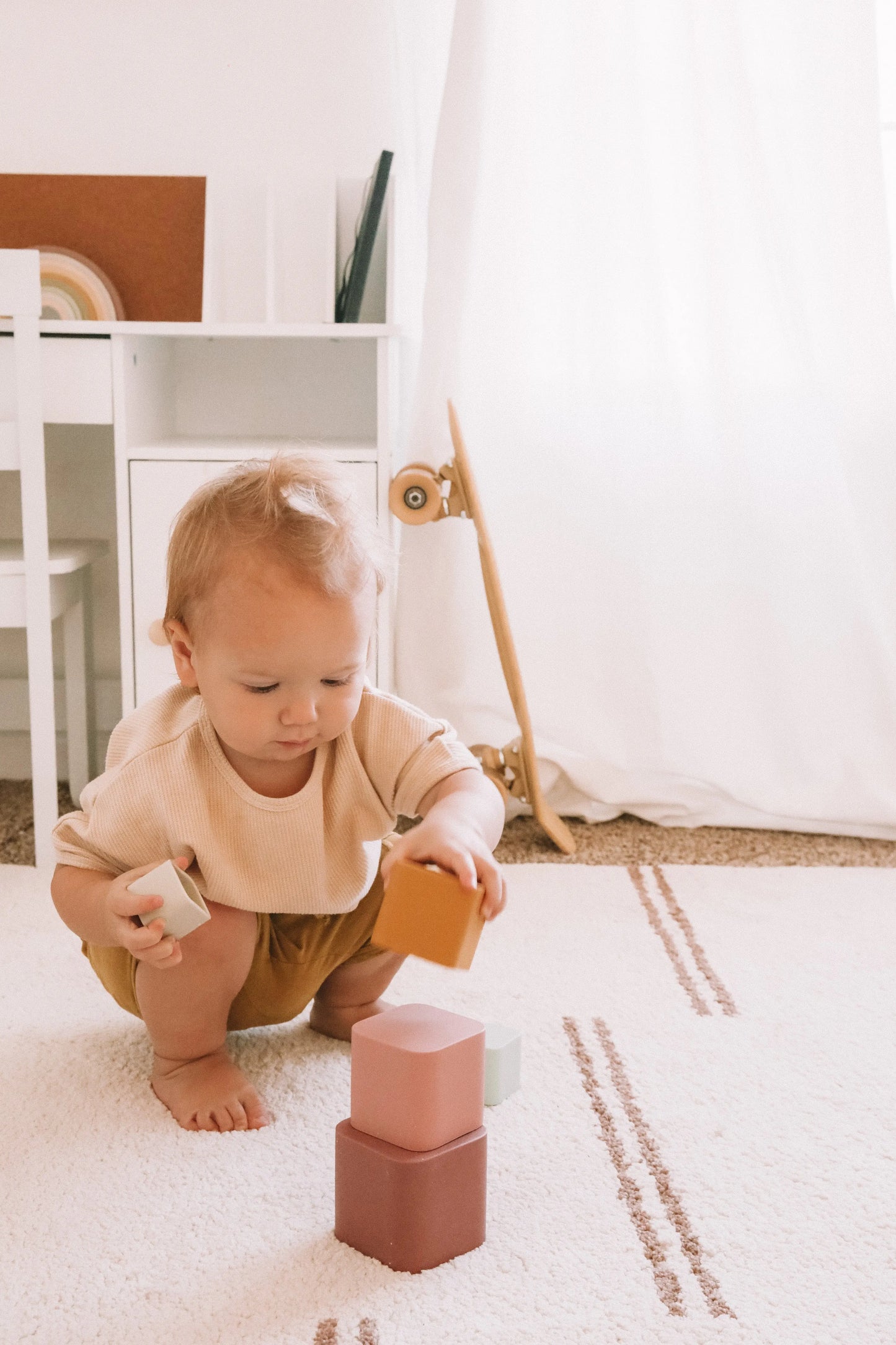Colorful silicone stacking toy cups arranged in a pyramid shape. Children playing with silicone stacking cups, creating a tower. A close-up of a child’s hands nesting silicone stacking cups inside each other.