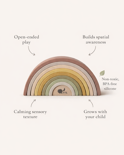 Rainbow-shaped toy with text highlighting its benefits on a white background. Montessori silicone rainbow toy for baby sensory play and fine motor skills