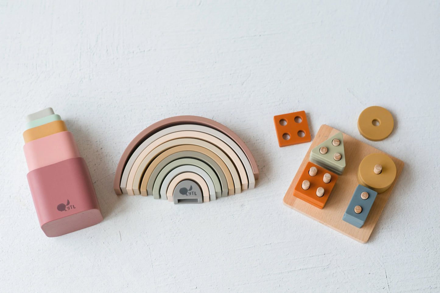 Jingle & Grow Play Kit with shape puzzle, rainbow stacker, stacking cups, and Leaf & Learn cotton play mat