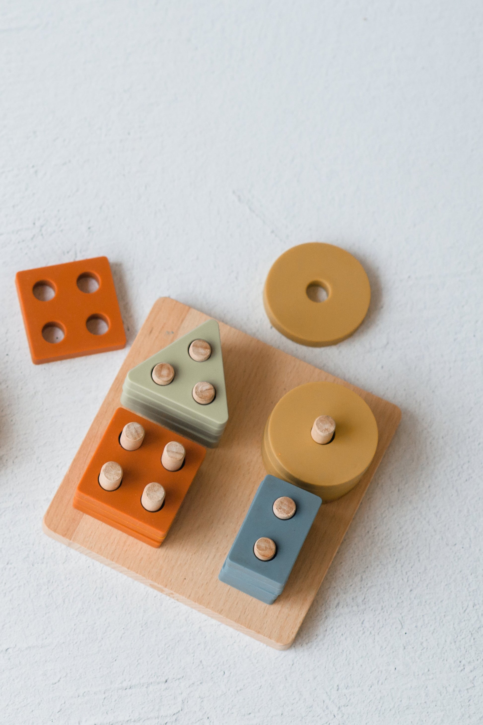 Montessori toddler puzzle toy with silicone shapes and wooden base for independent learning play
