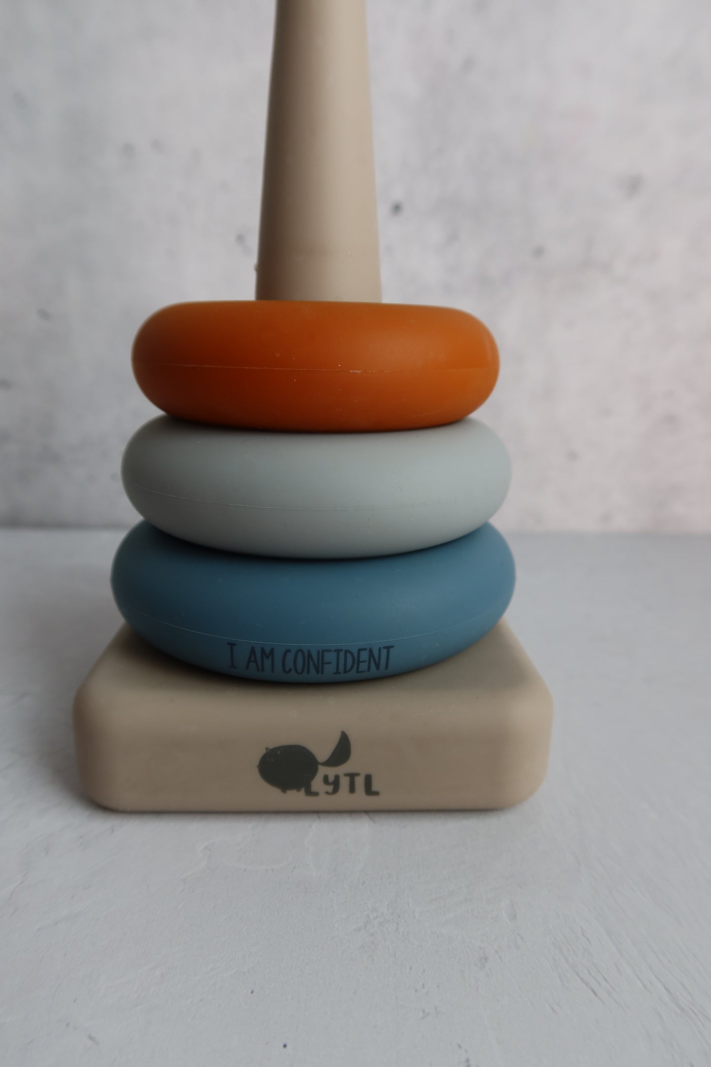 Montessori baby toy with positive affirmation message and stacking rings for confidence building