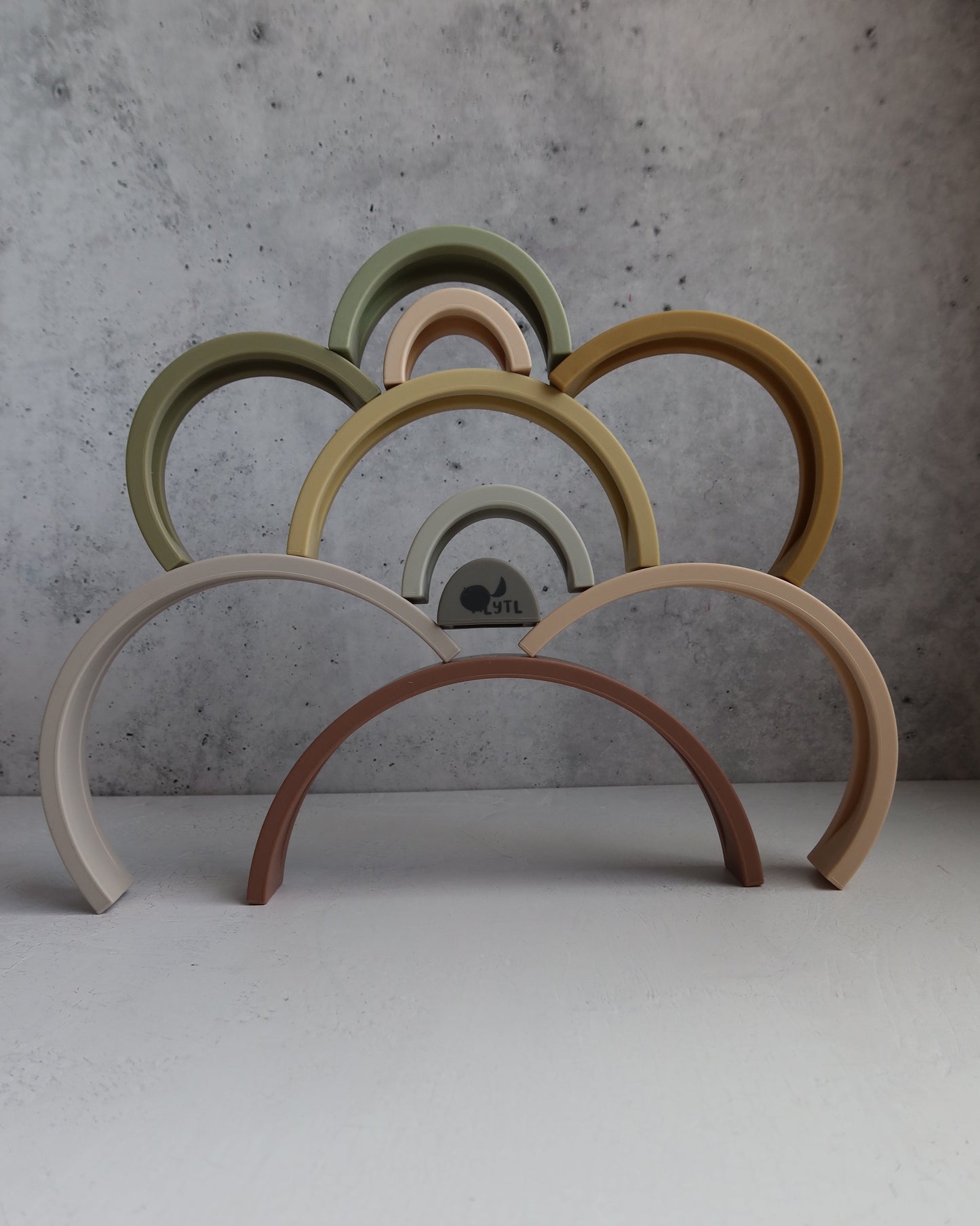 Close-up of 10 layer earthy silicone Montessori rainbow arches for stacking and balancing