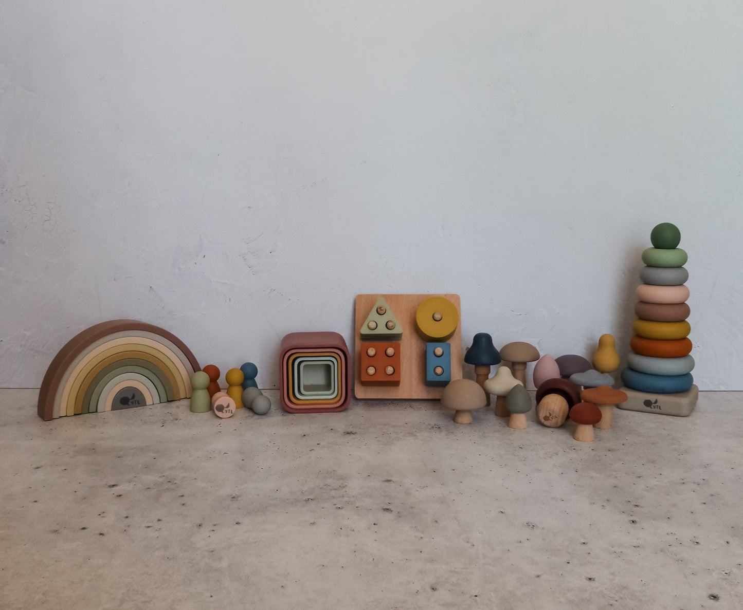 Montessori toy bundle with silicone stacking cups, rainbow stacker, puzzle, mini peg dolls, mushrooms, and ring stacker